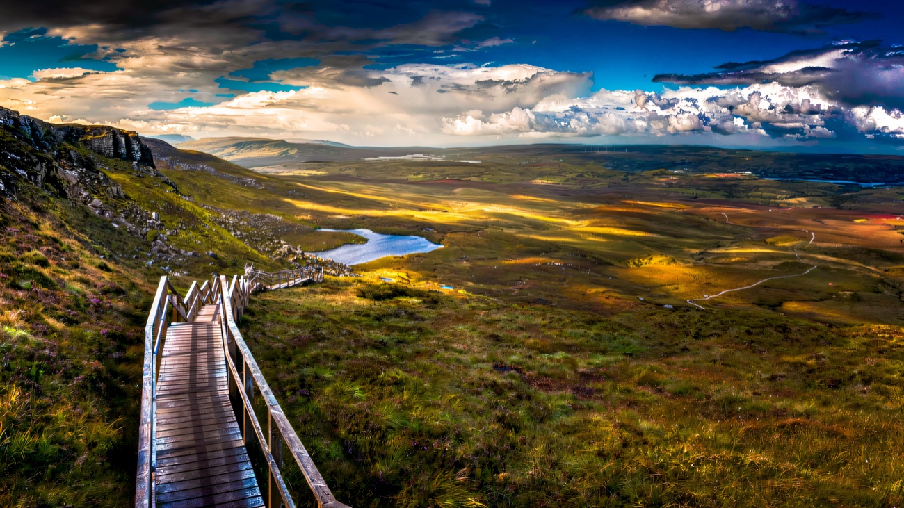 The famed boardwalk stretches out across the blanket bog toward a small mountain lough.