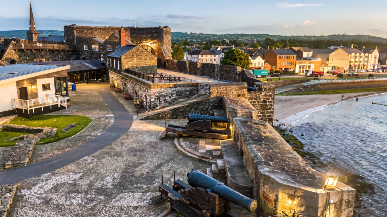 Dusk aerial over Carrickfergus Castle, the lough and the town