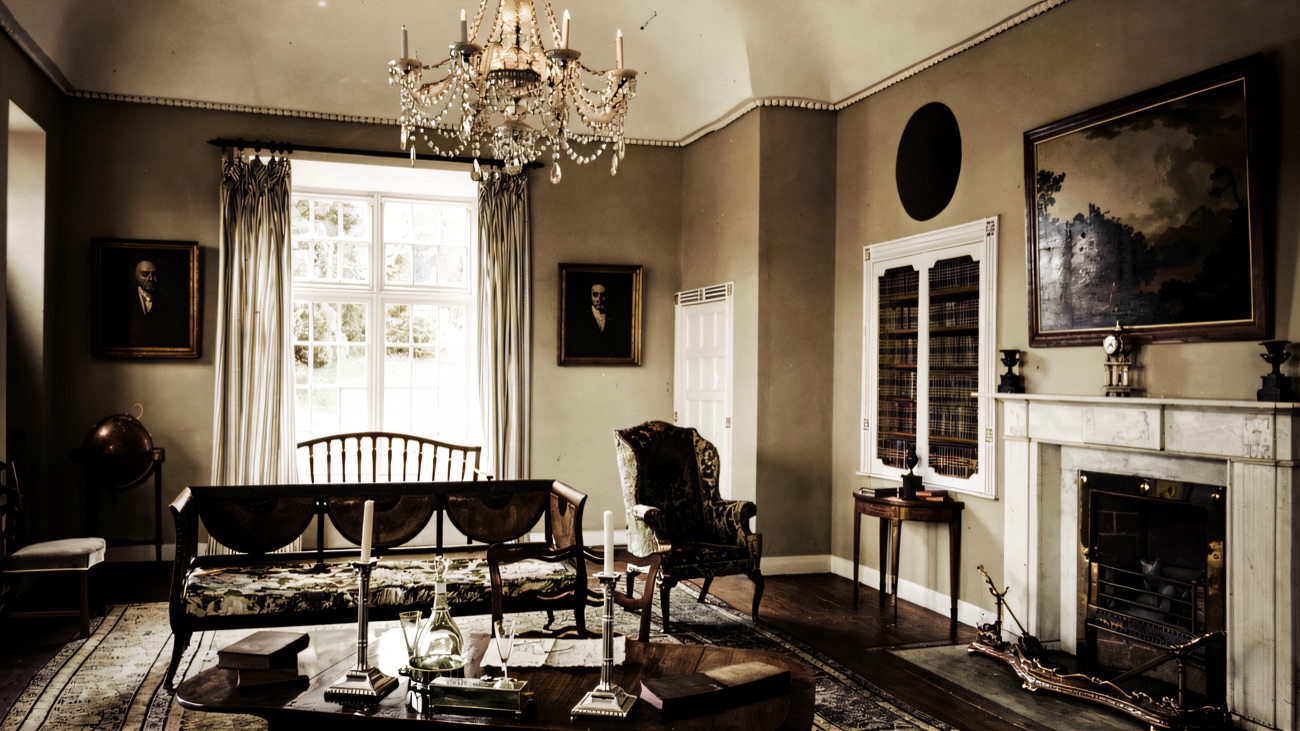 The elegant drawing room inside Derrymore House, with a crystal chandelier, marble fireplace and family portraits