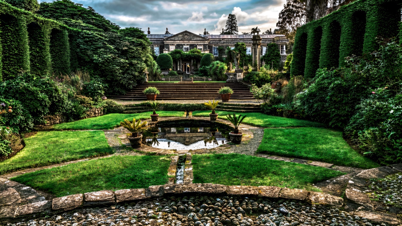 The Italian garden at Mount Stewart with clipped hedges, a pool and the grand house behind