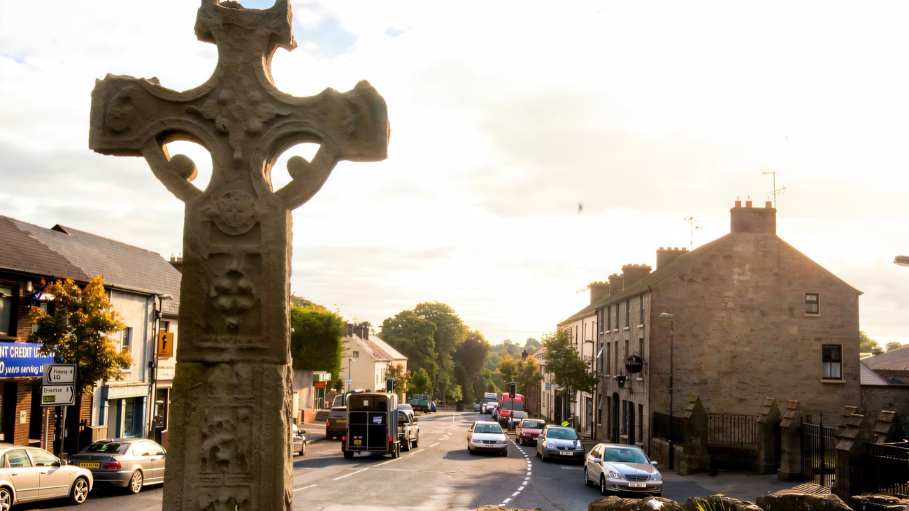 The cross stands sentinel at the top of Donaghmore's village street, part of everyday life here for centuries.