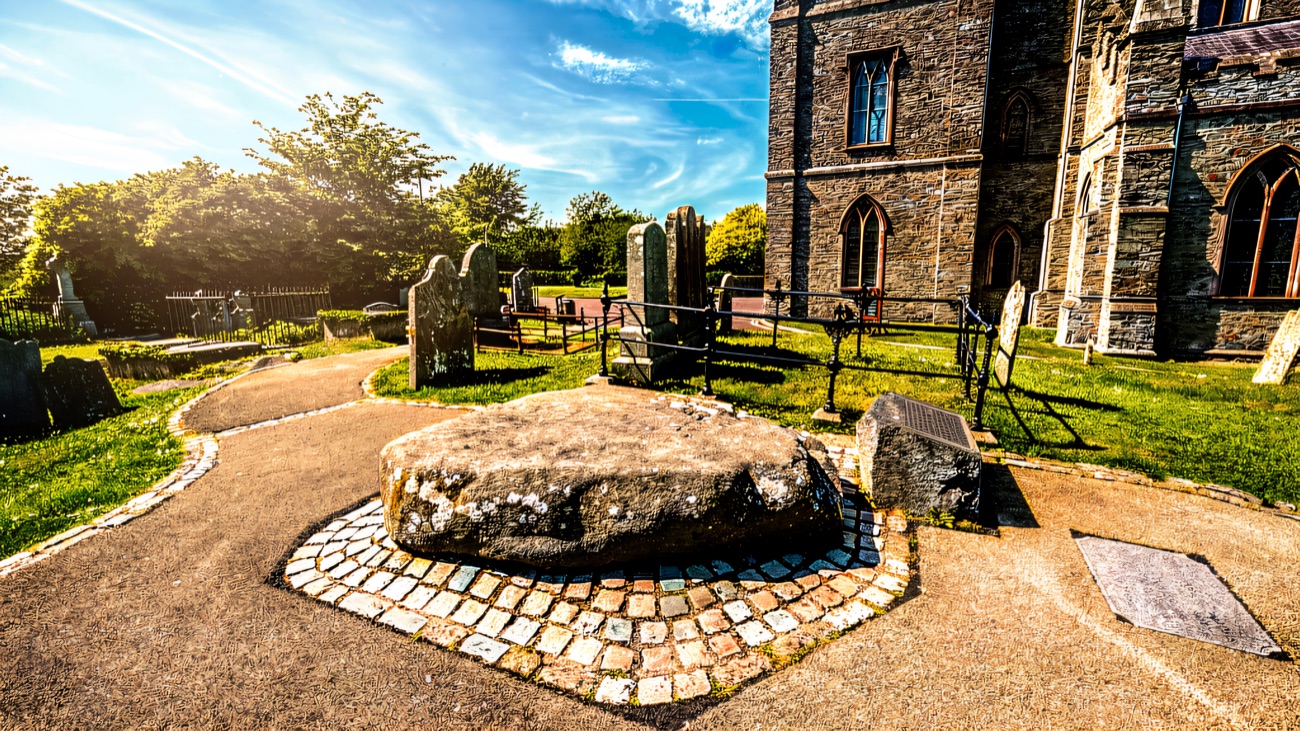 The memorial stone in its setting beside the cathedral and old graveyard