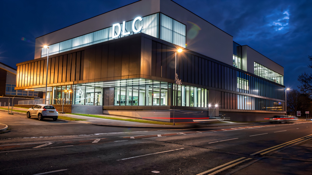 The lit-up front of the centre at dusk