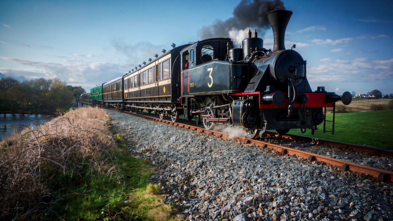 Steam locomotive No. 3 hauling its vintage carriages along the loughside line at Downpatrick.