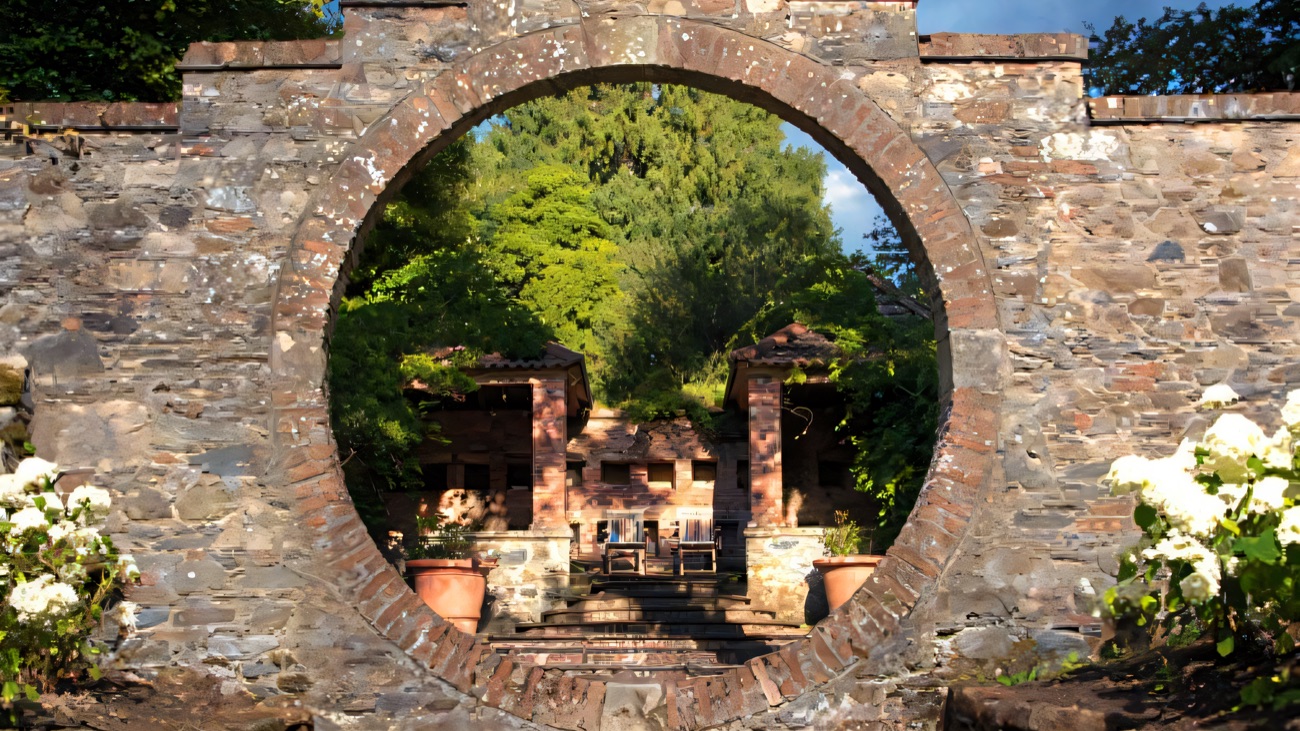 The circular stone moon gate of the Moon Garden looking through to the garden beyond