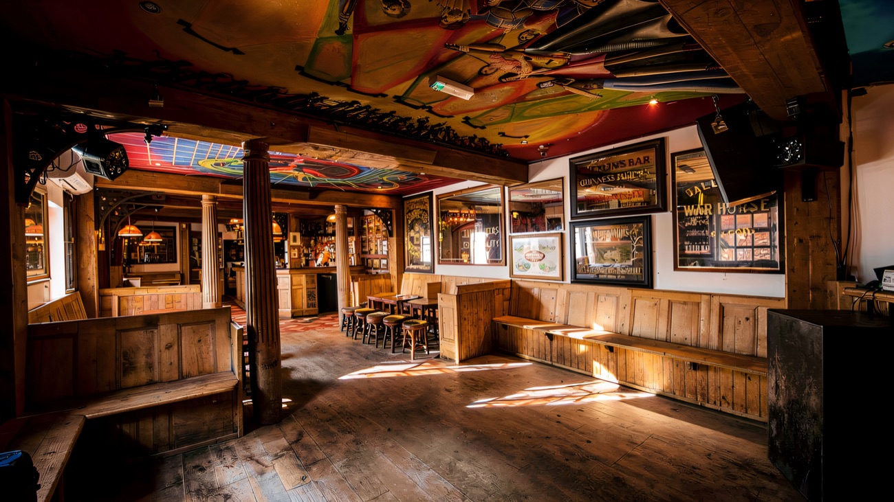 The back room with its brightly painted ceiling mural and long pine benches