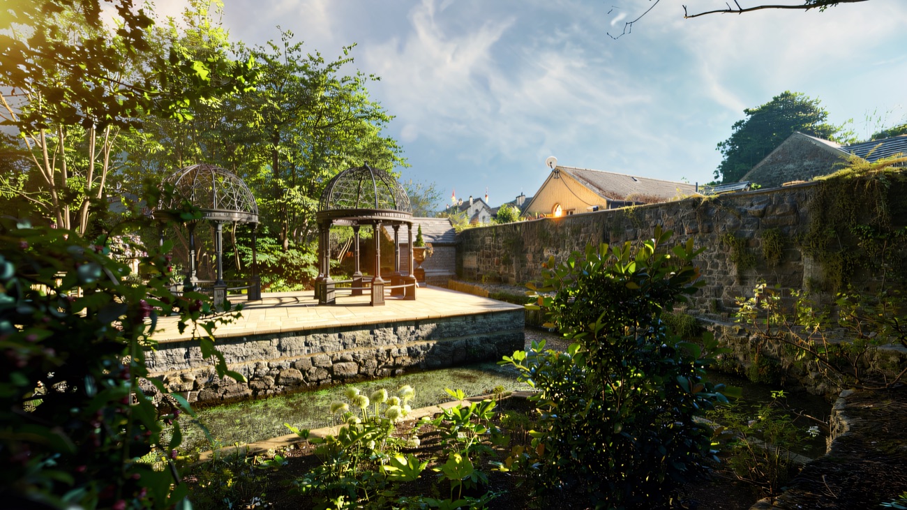 A wrought-iron garden pavilion set among stone walls and greenery in the Dunadry gardens.