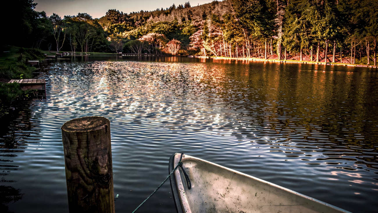 Evening light on the water with a boat moored at the jetty