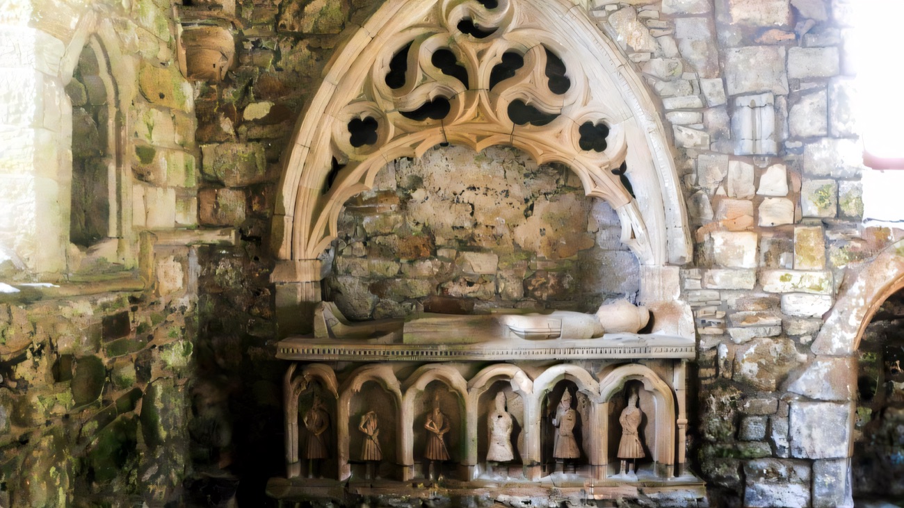 The medieval O'Cahan tomb in Dungiven Priory, a carved effigy under a gothic canopy above six kilted warrior figures