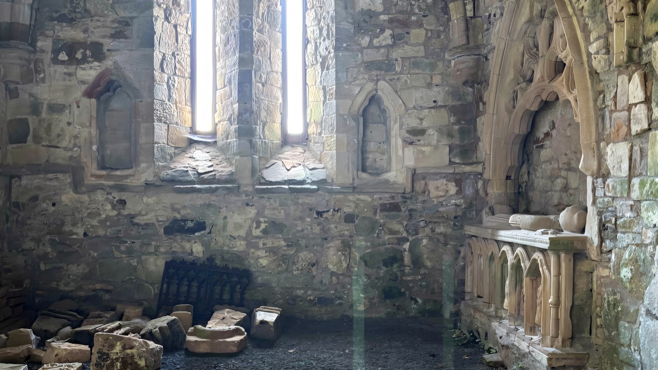 Inside the chancel, twin lancet windows above the sheltered tomb