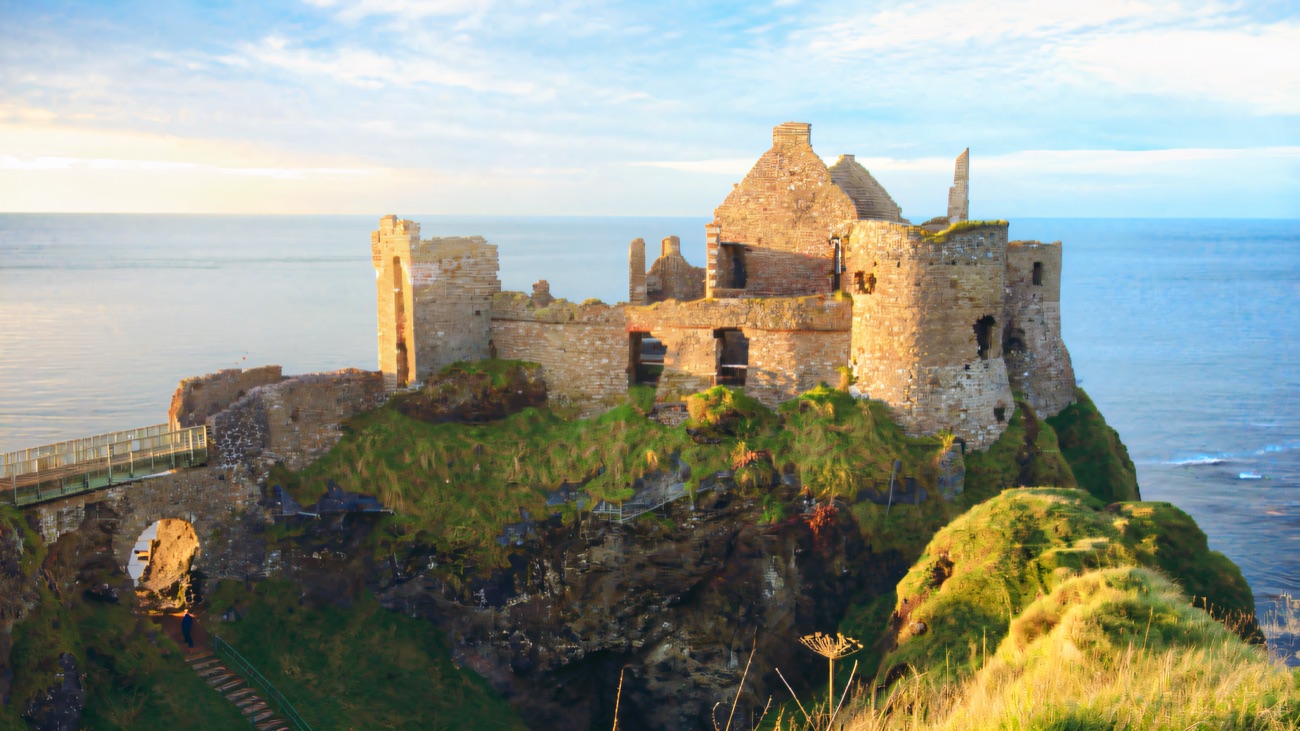 Dunluce Castle on its cliff-edge crag above the Atlantic, with the stone steps and bridge
