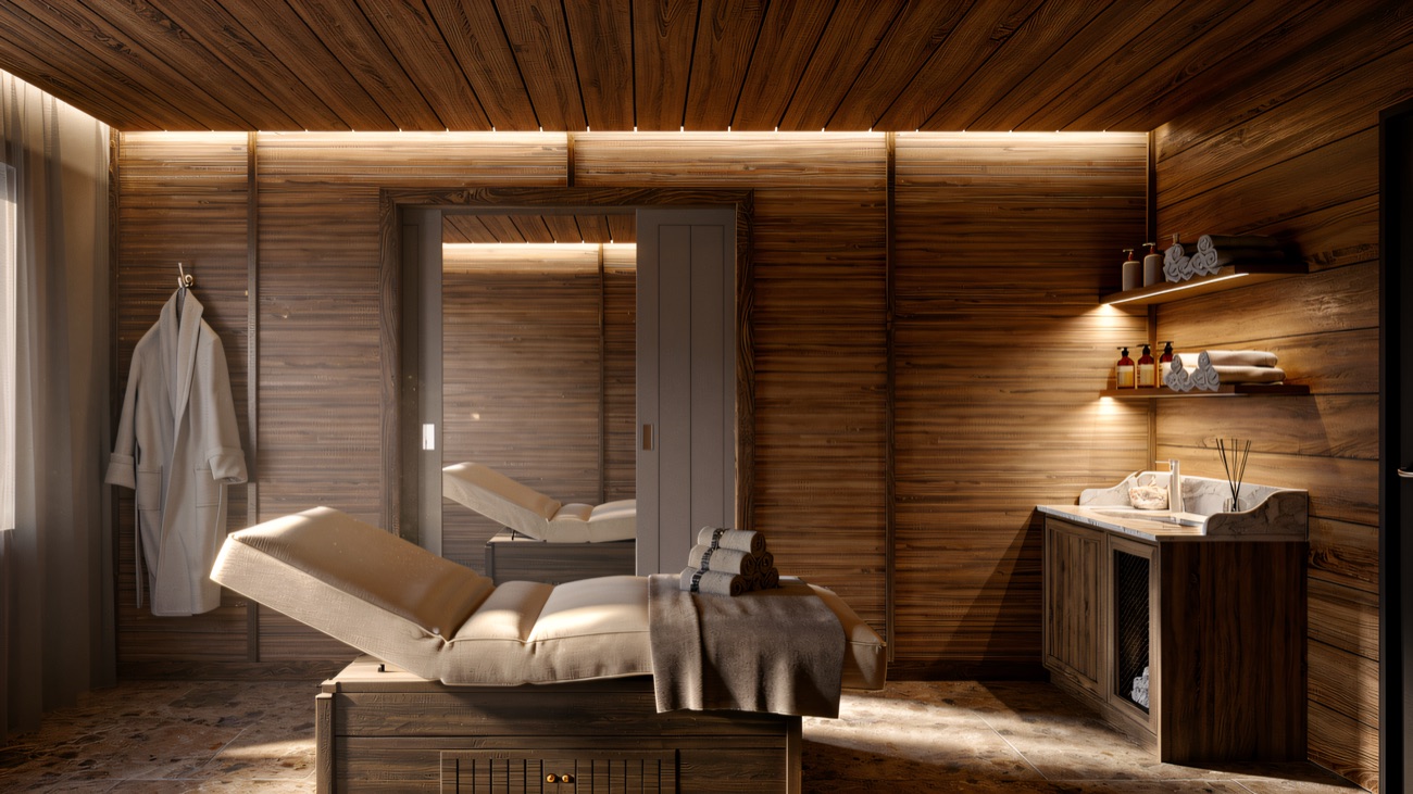 A calm treatment room in oak and soft light, twin loungers and folded towels ready.