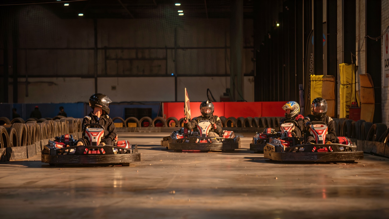 Karts lined up on the grid under the lights at Eddie Irvine Sports