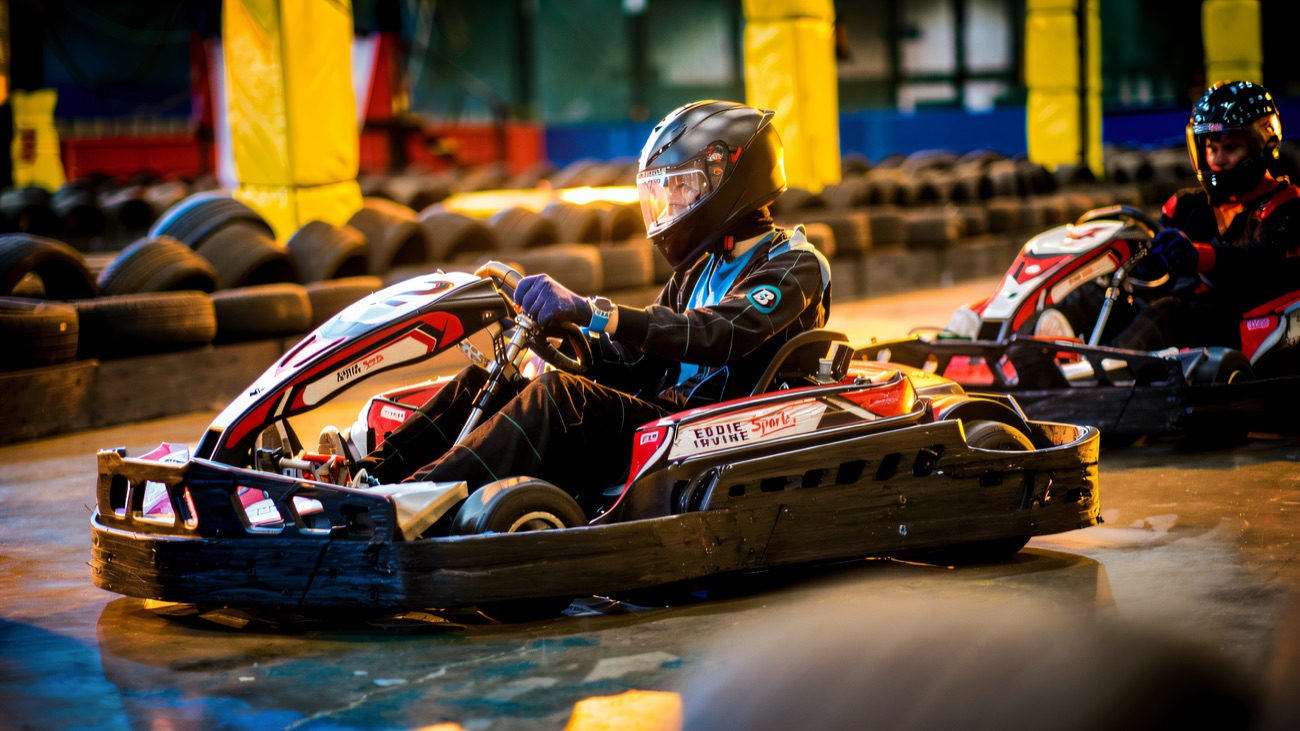 A driver cornering in an Eddie Irvine Sports kart