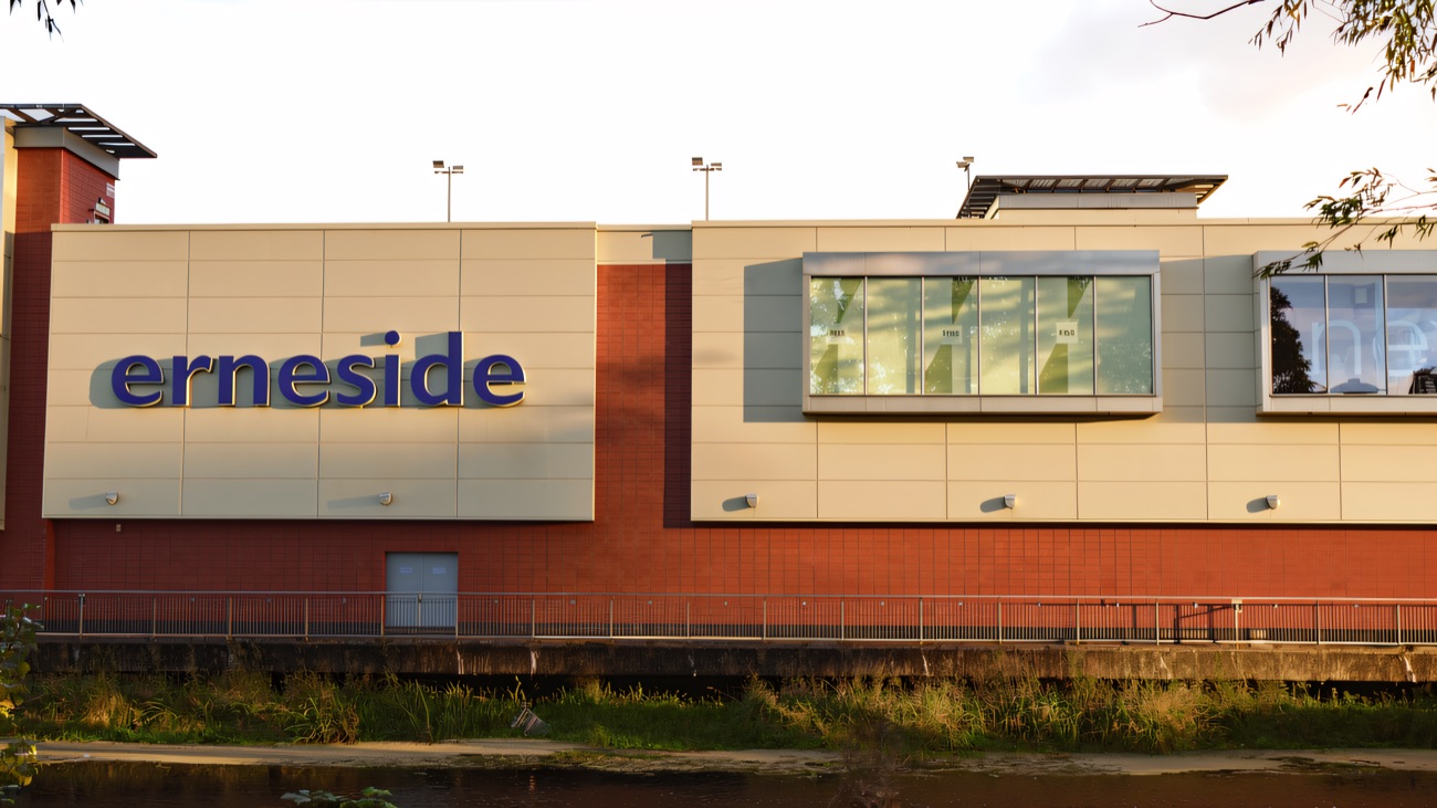 The blue Erneside sign above the river wall, the Erne in the foreground