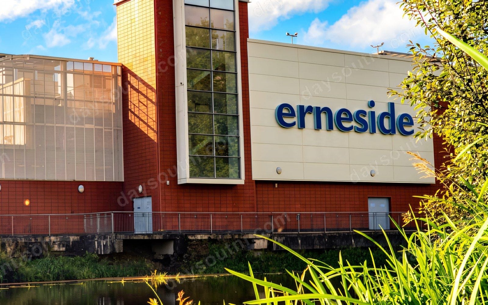 Erneside Shopping Centre's brick tower and glass frontage rising over the River Erne in Enniskillen