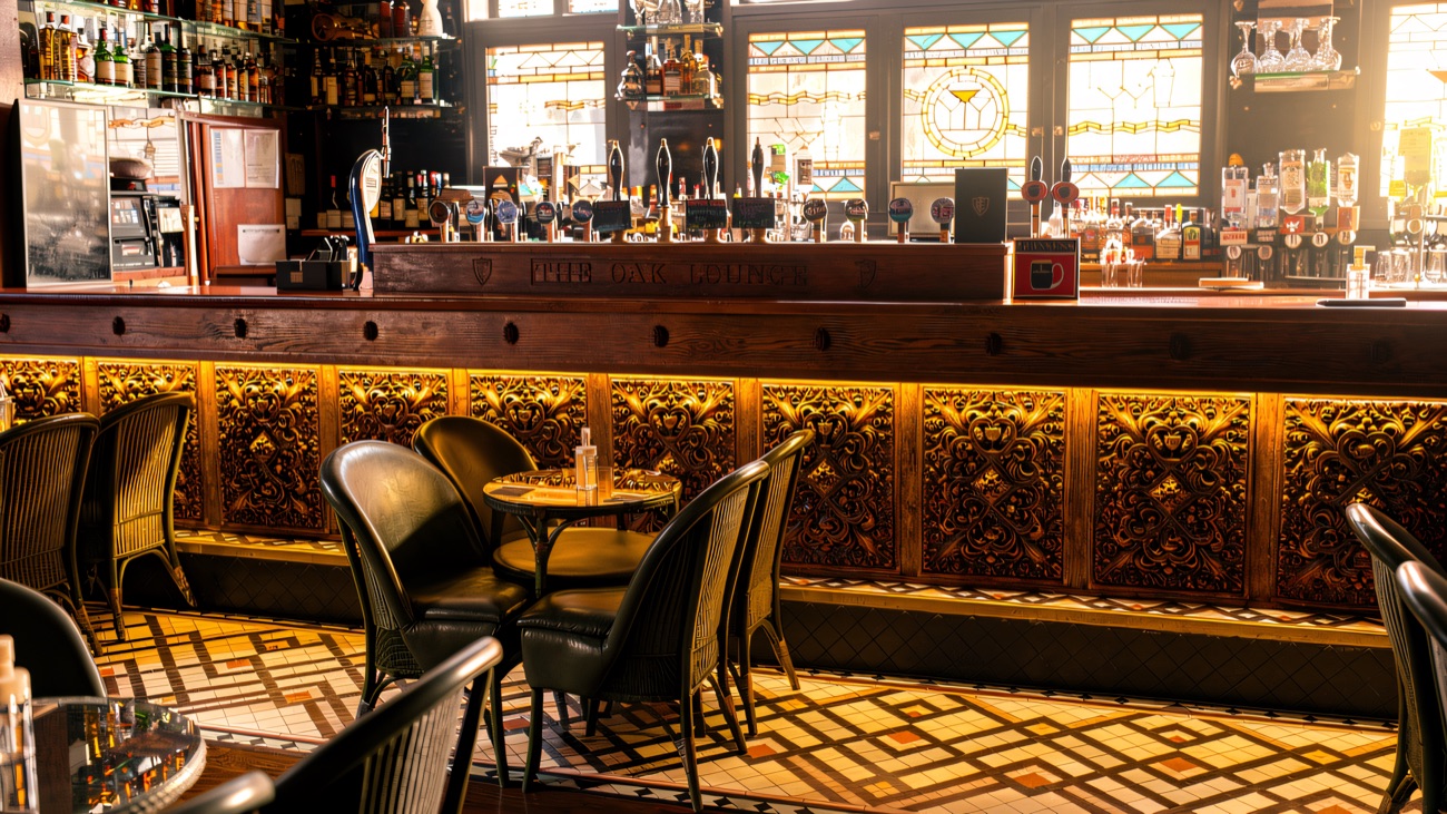 The Oak Lounge inside, with tiled floor, tables and the bar counter