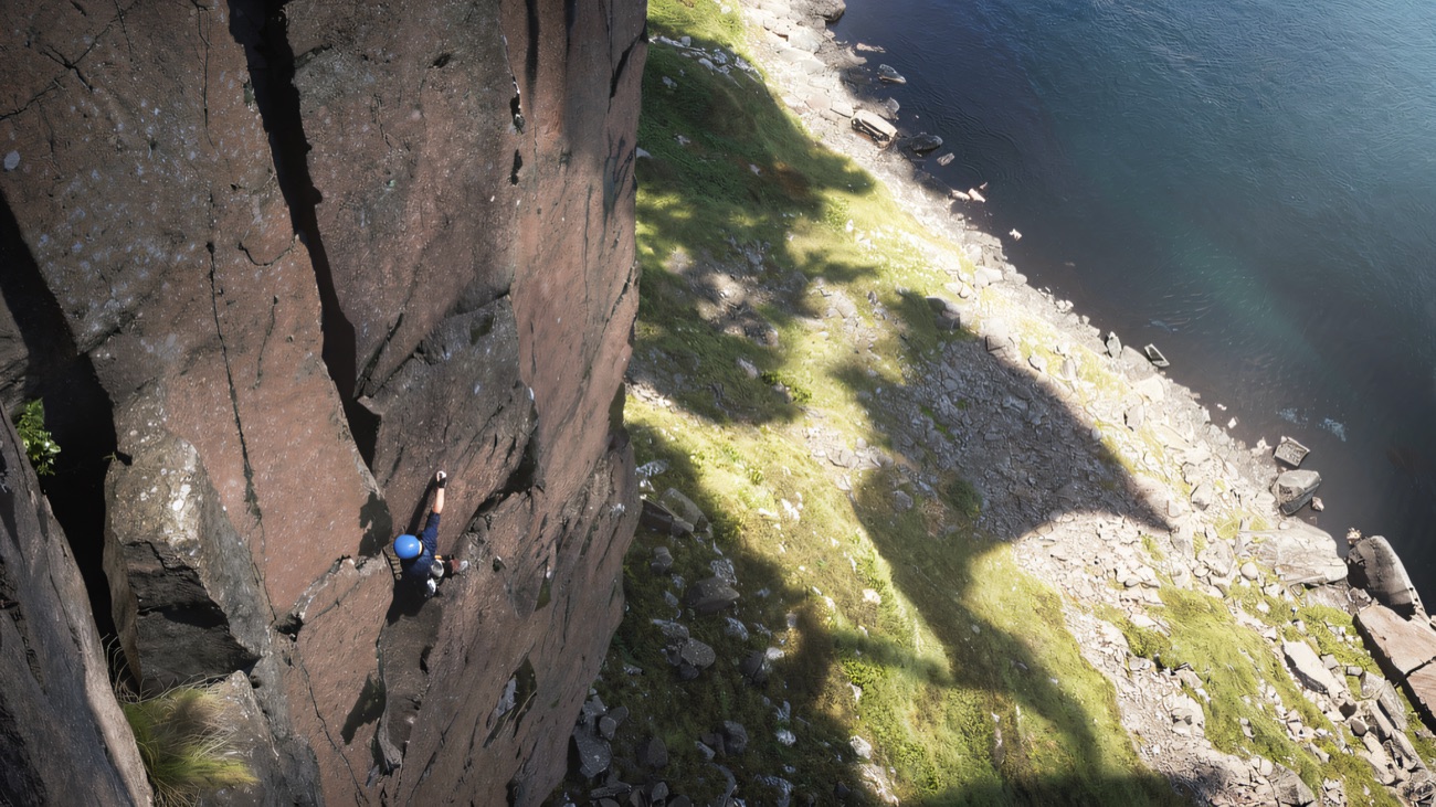 Looking down the cliff to the boulders and open sea far below