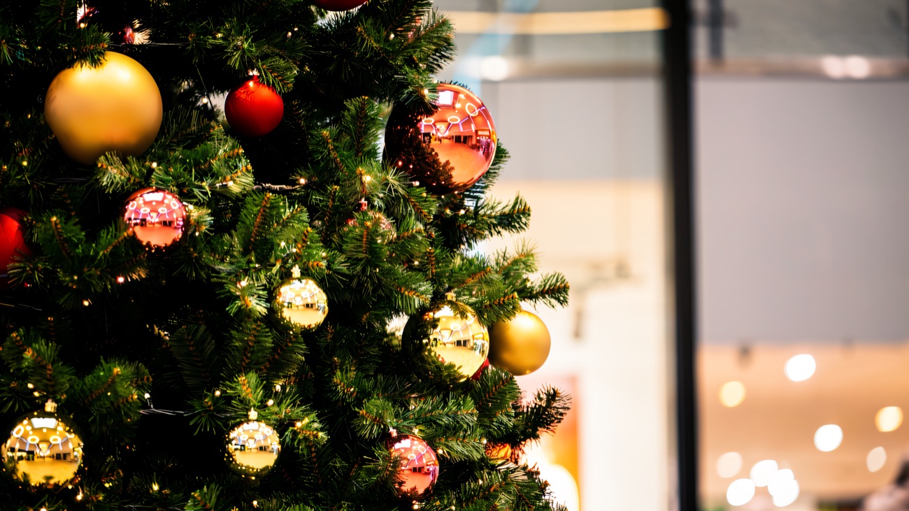 A decorated Christmas tree in the Fairhill mall walkway, shopfronts soft in the background
