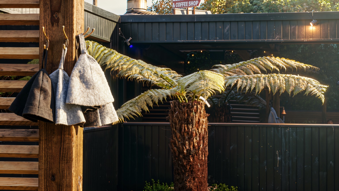 Sauna hats hanging ready by the greenery