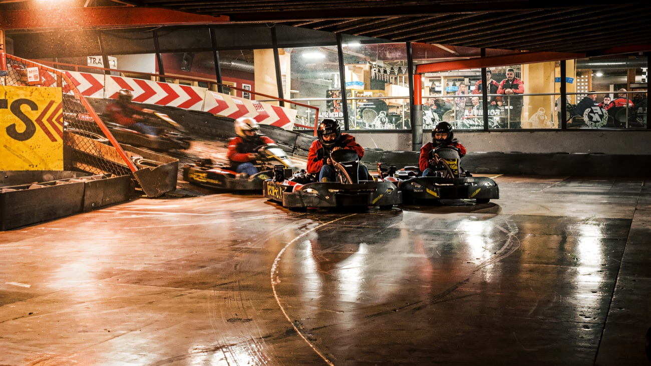 Racing round the indoor circuit with the viewing gallery looking on