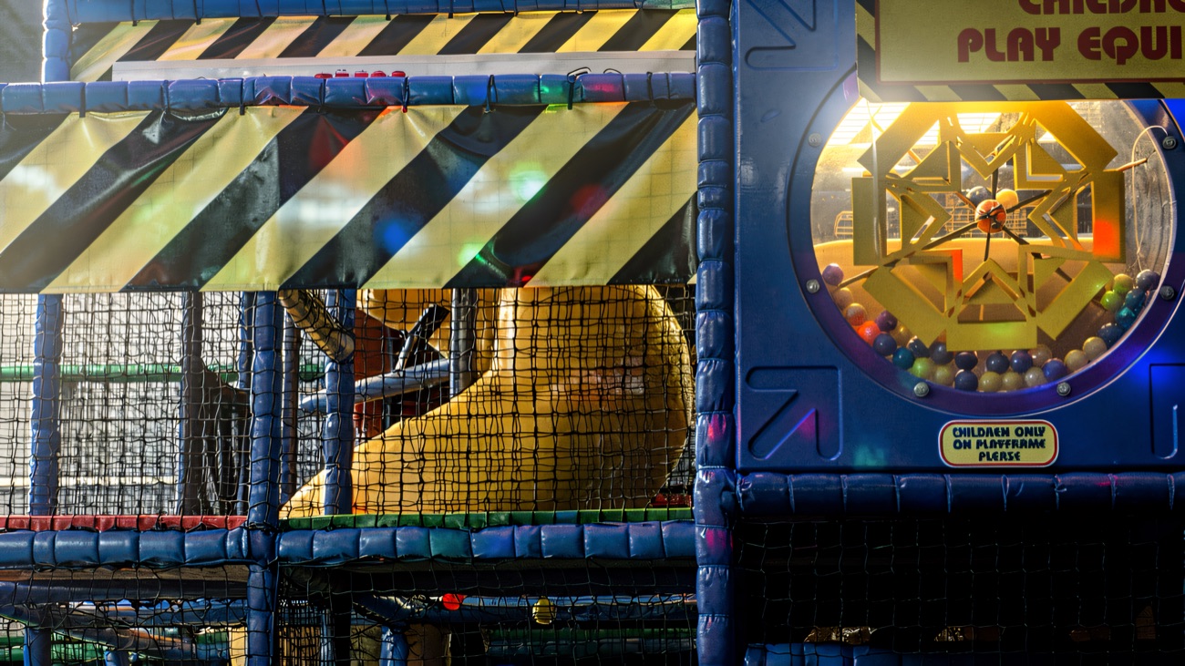Close view of the play frame with netting, tube slide and ball wheel