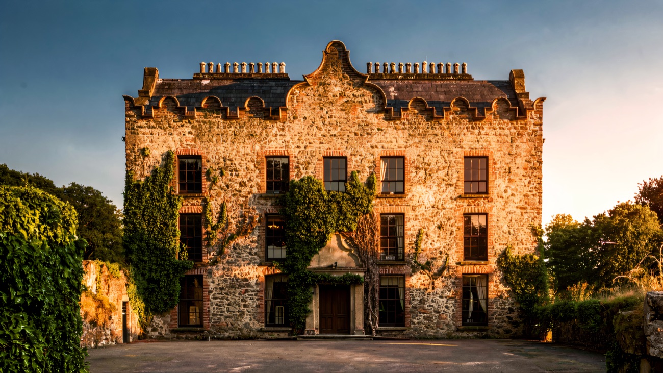 The 17th-century Galgorm Castle in the sun, its Jacobean front draped in ivy