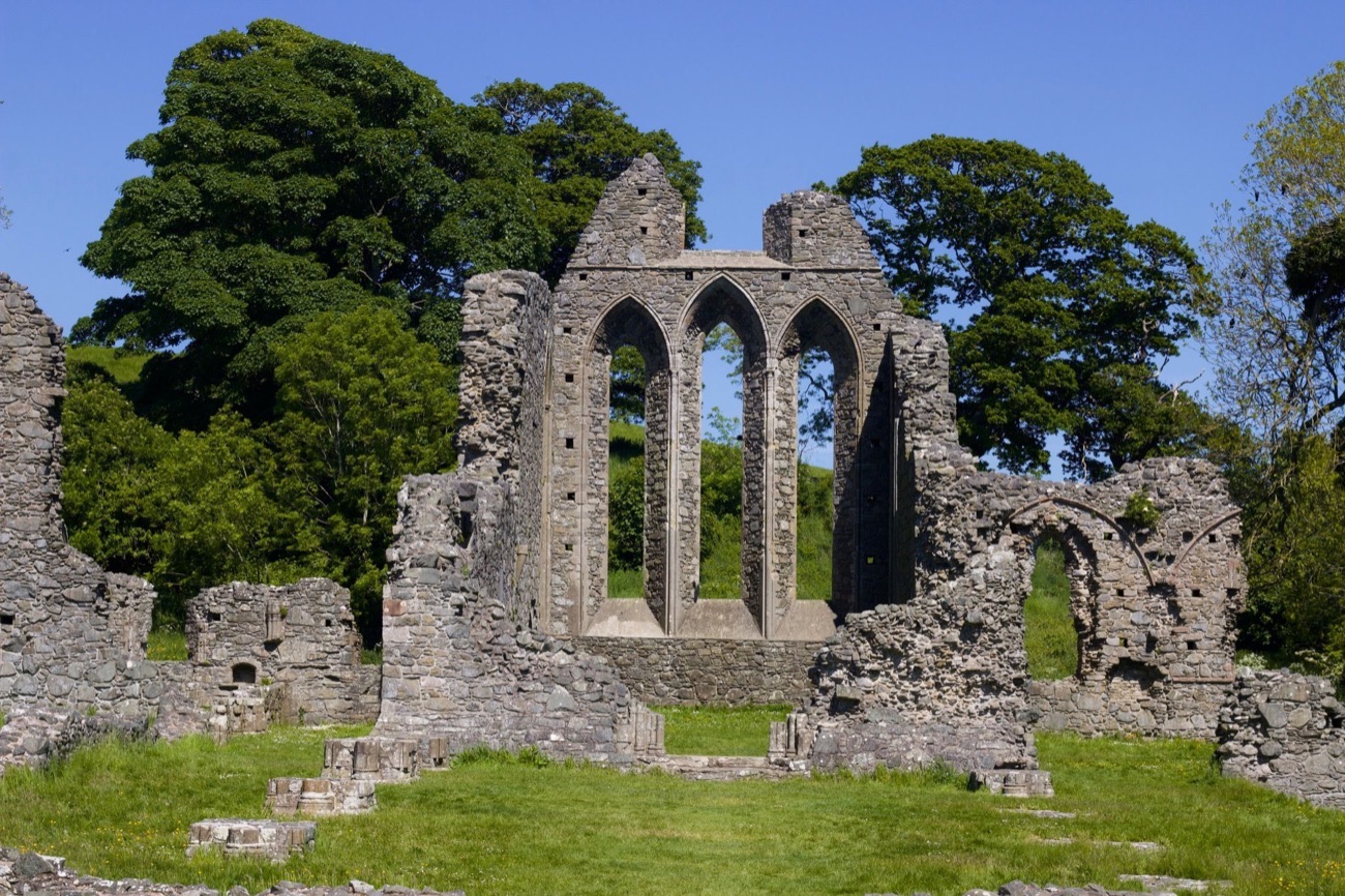 The tall lancet windows of the ruined abbey church at Inch Abbey