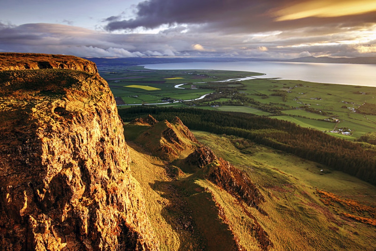 The basalt cliff edge of Binevenagh in golden evening light above Lough Foyle