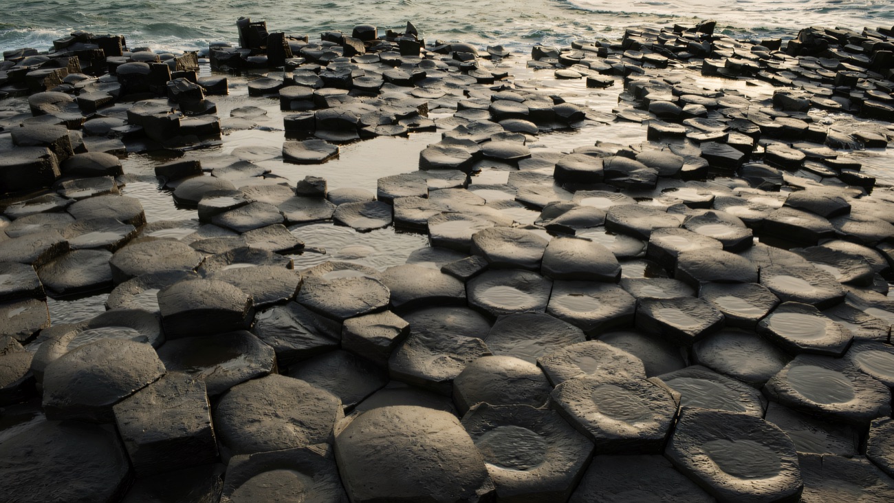 Close up, the hexagonal columns fit together like tiles worn smooth by the tide.