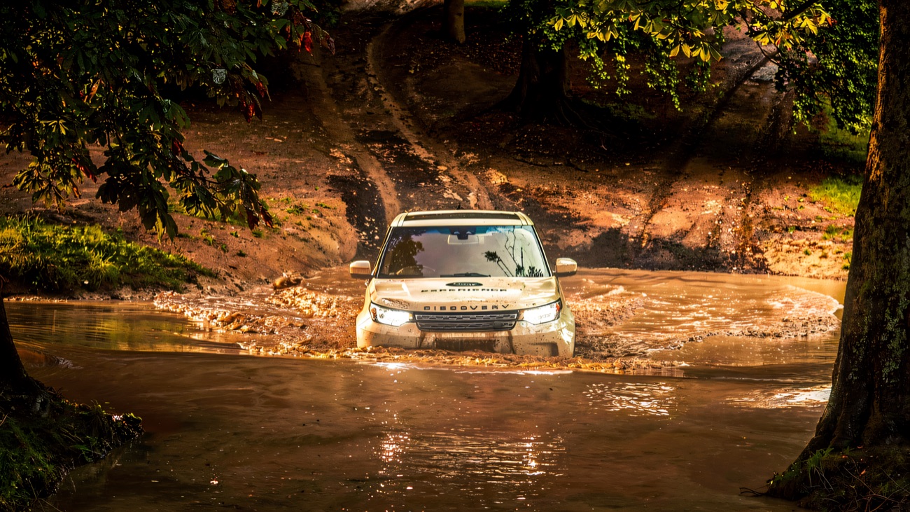 Land Rover wading through a water splash on the off-road course
