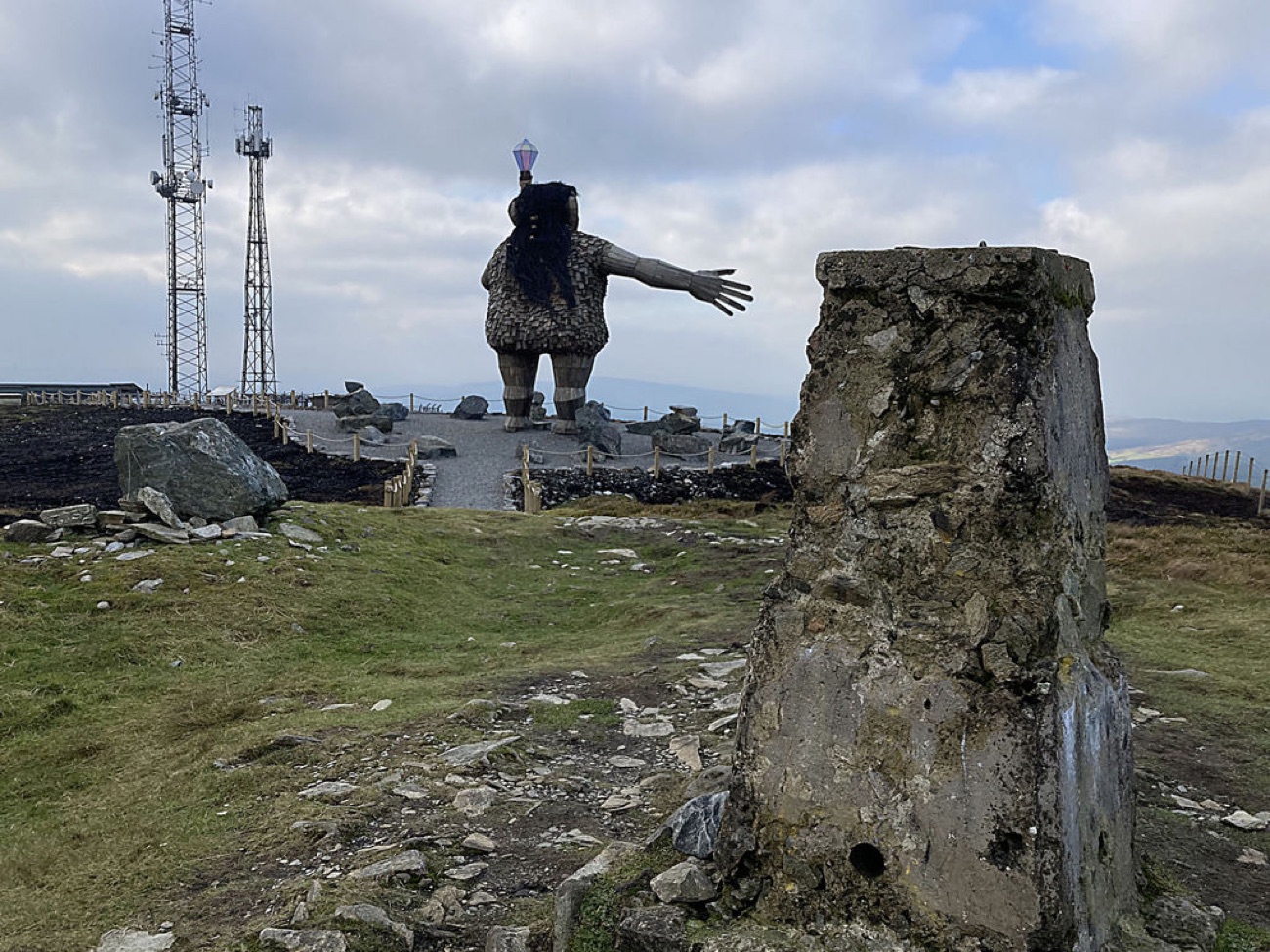 Darach the Guardian, a giant wooden figure with arms outstretched, on the summit of Mullaghcarn.