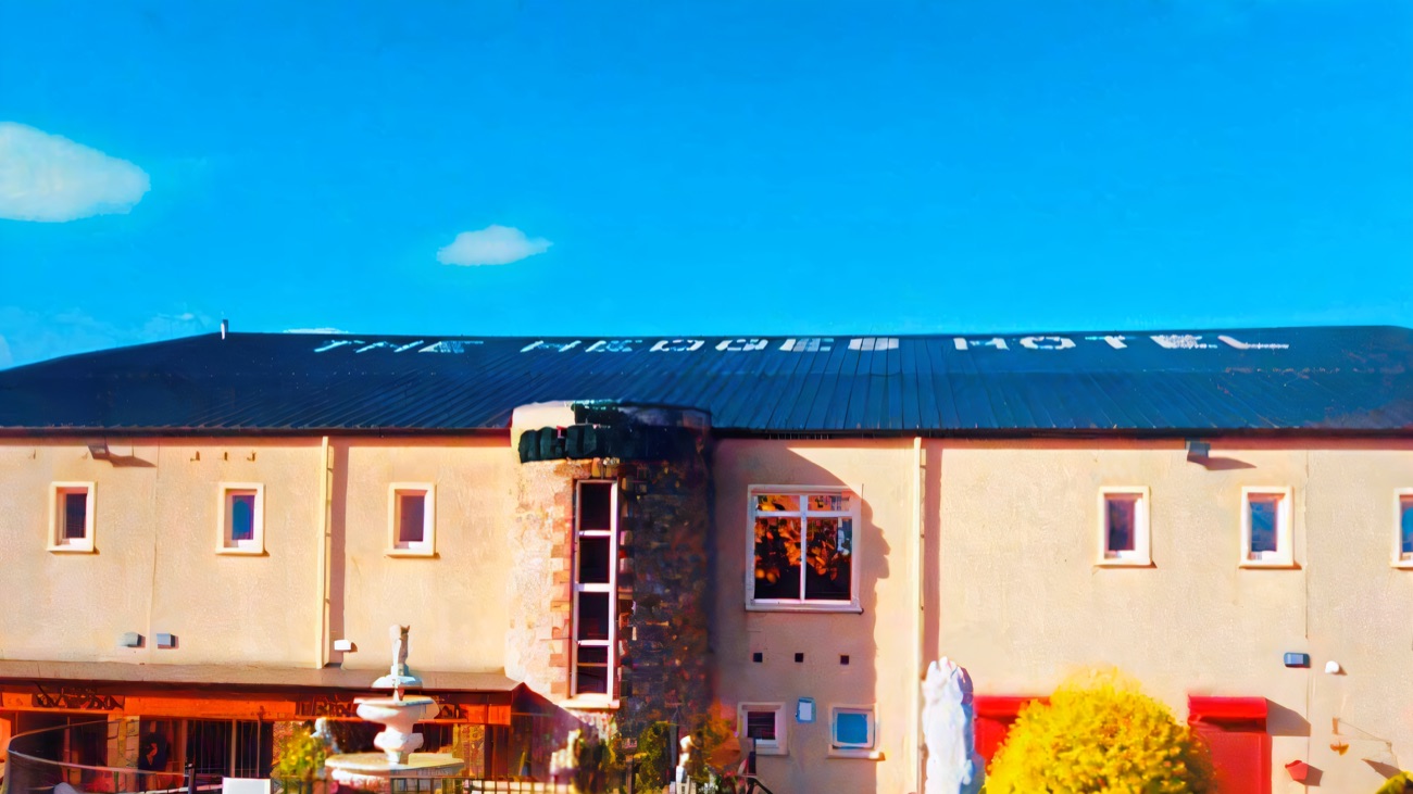 The Hedges Hotel on the estate, with its name across the roof and a fountain out front