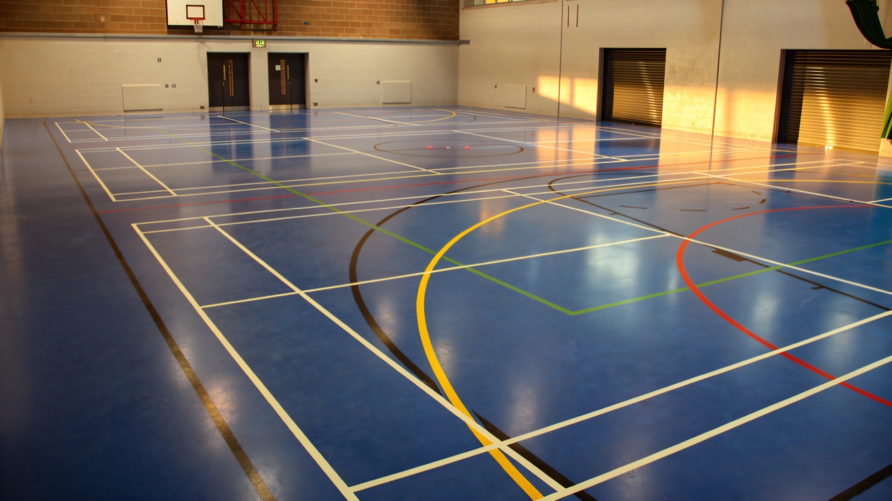The main sports hall with marked-out courts and basketball hoop