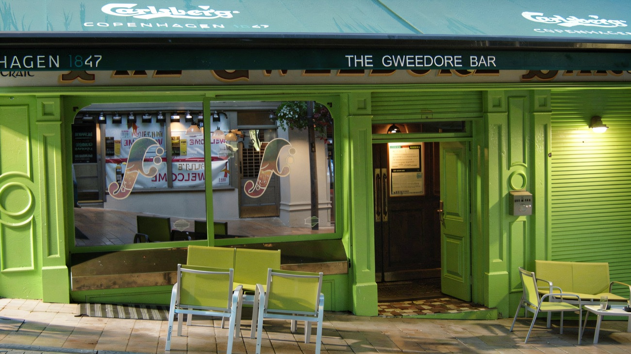 The bar's ground-floor frontage and awning in daylight