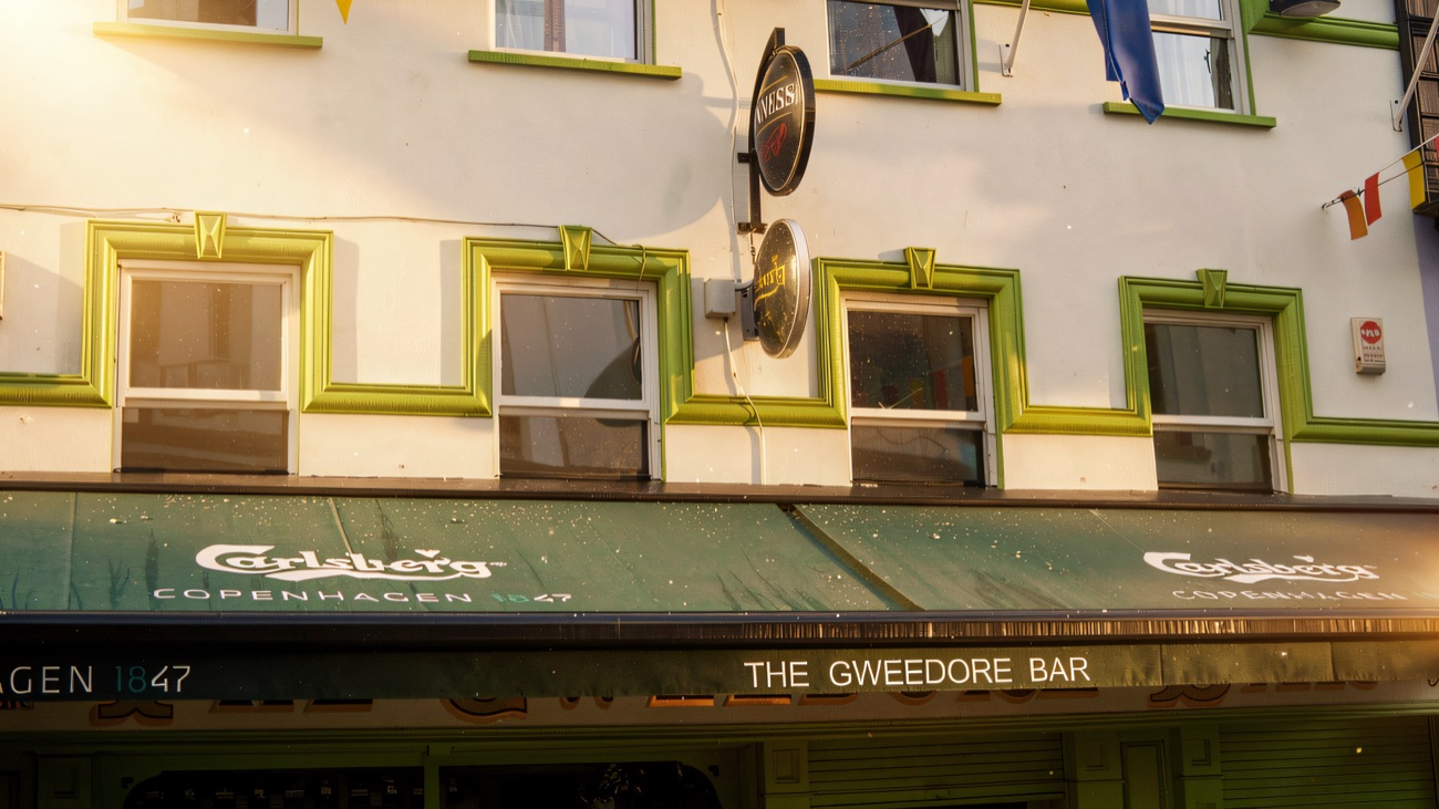 Flags and painted signage on the upper storey of the Gweedore