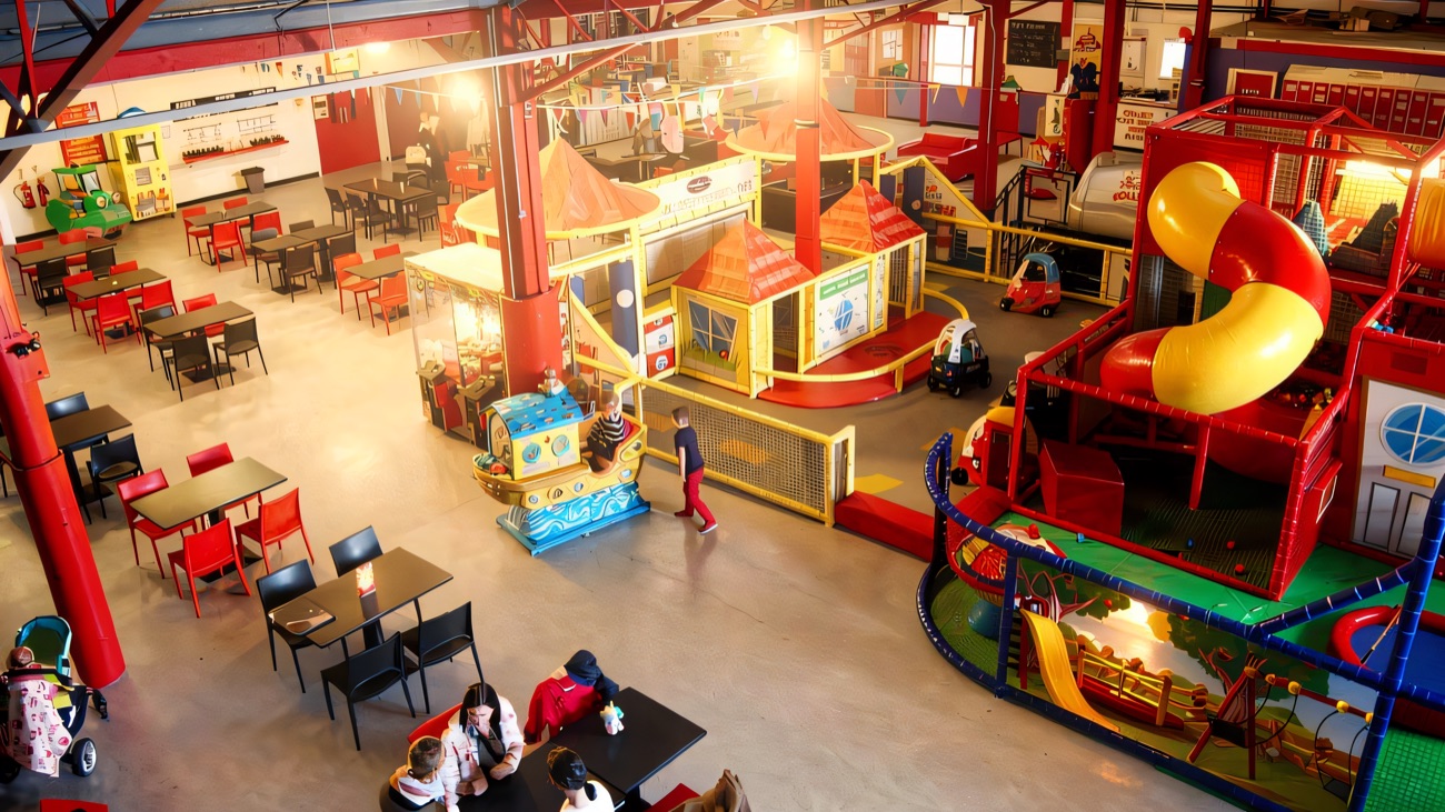 Looking down over the whole centre, with café tables, play houses and the big red frame