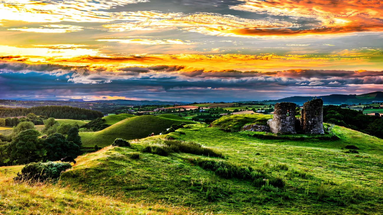 A blazing sunset behind the ruin on its hilltop above Newtownstewart