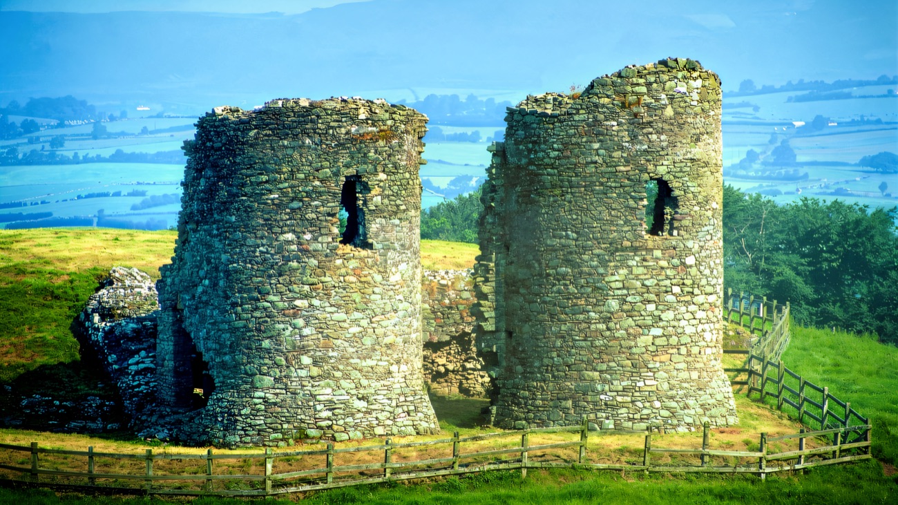 The paired towers close up, hazy blue hills fading into the distance