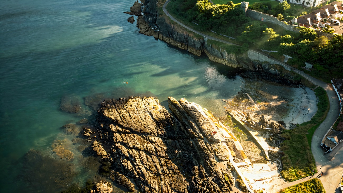 From above, the path threads along the rocky shore near Bangor