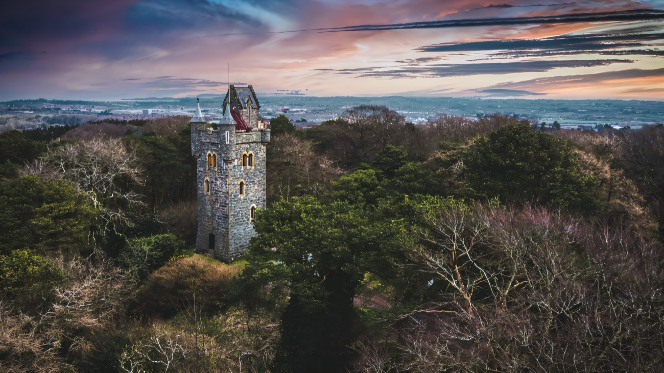 Aerial view of Helen's Tower on its wooded hilltop above Belfast Lough at dusk