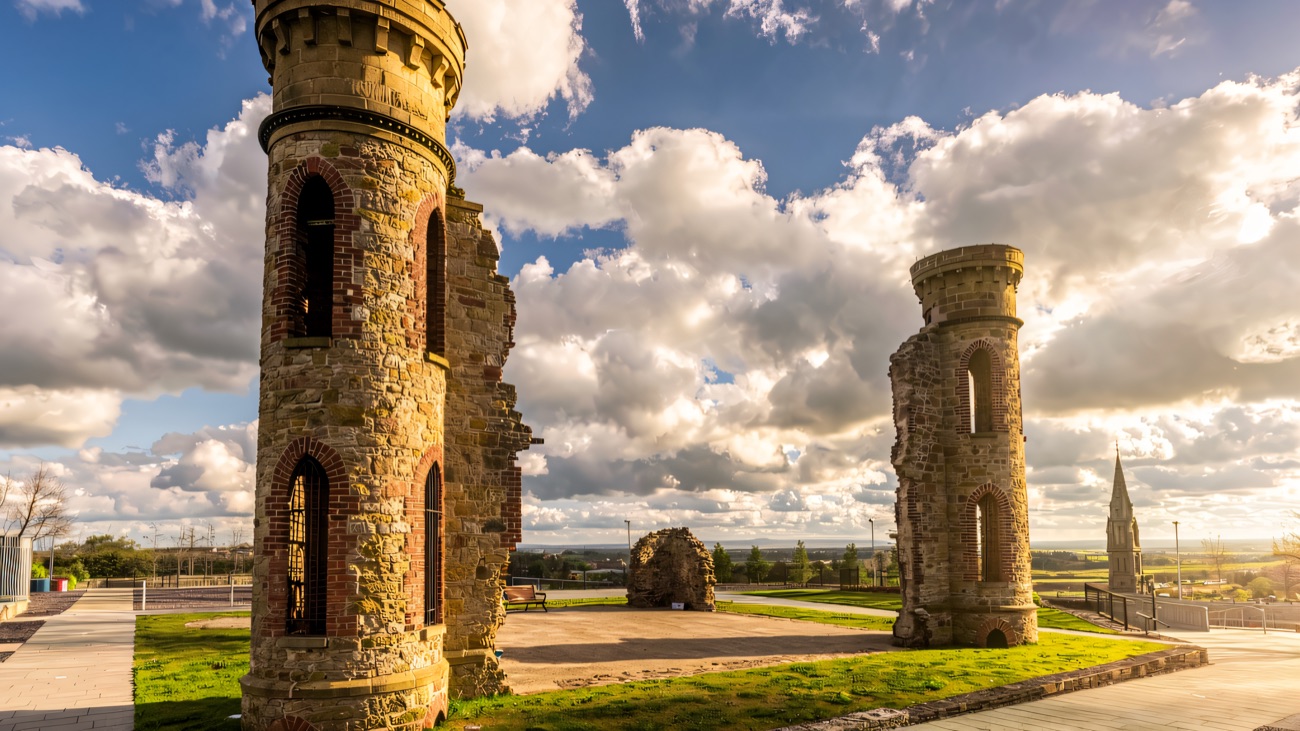 The two ivy-free mock-castle towers crowning the Hill of the O'Neill, the ancient inauguration ground of the Gaelic lords of Tyrone.