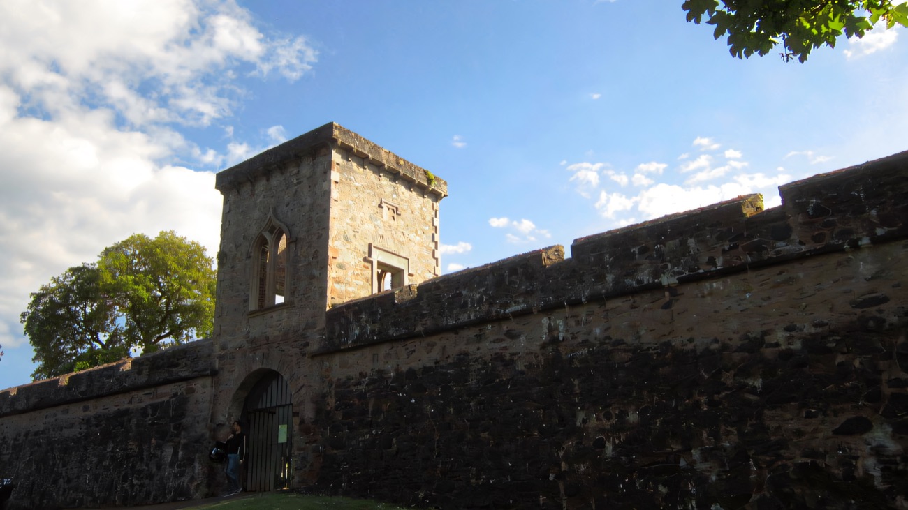 The stone curtain wall and gatehouse tower of Hillsborough Fort rising against a blue sky