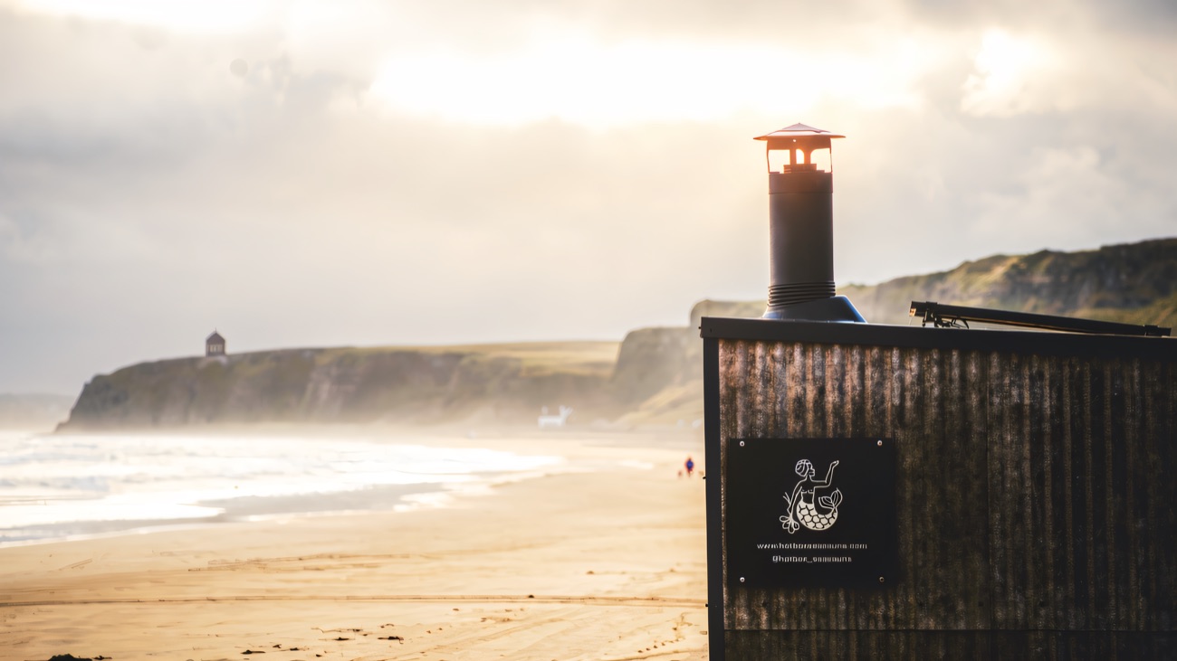The chimney with Mussenden Temple on the clifftop beyond
