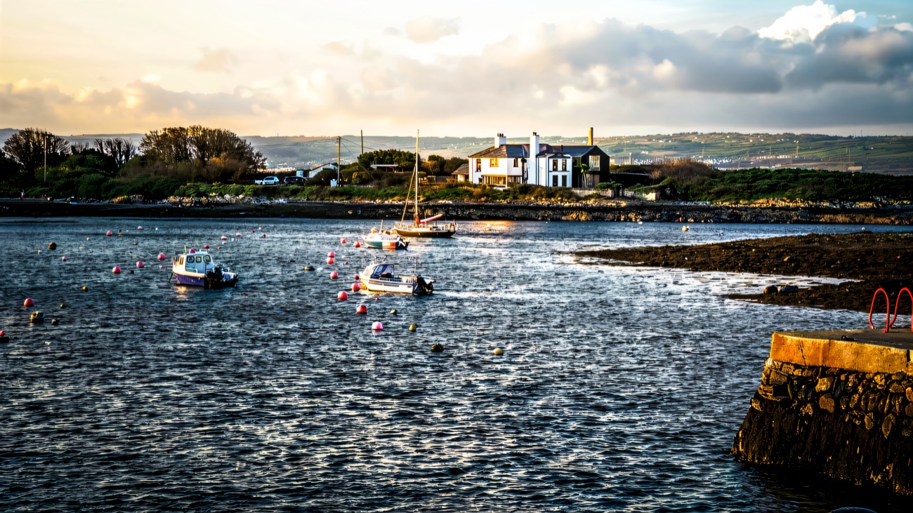 Groomsport harbour with small boats moored and a swimming ladder at the slipway