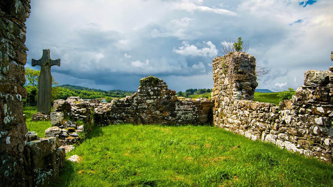 The ruined church and its plain high cross on the island in Lower Lough Erne.