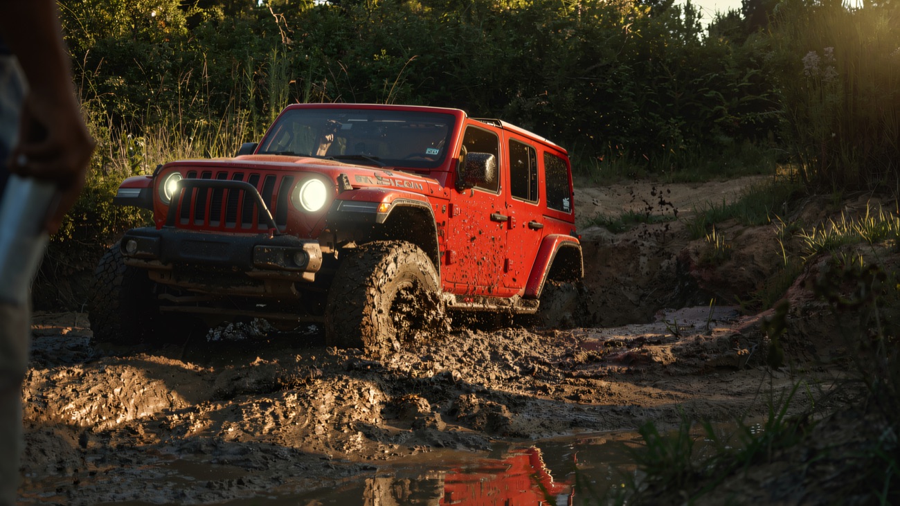 A 4x4 powers through deep mud on the off-road course
