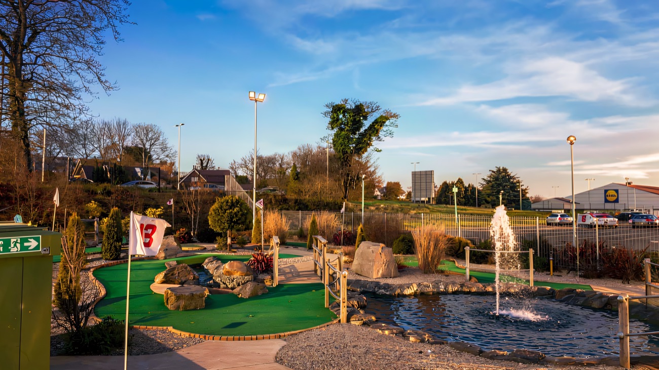 The landscaped outdoor course winds around a bubbling fountain and rockeries