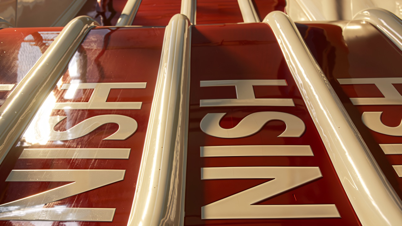 Looking up the red multi-lane wave slide with FINISH marked across the lanes