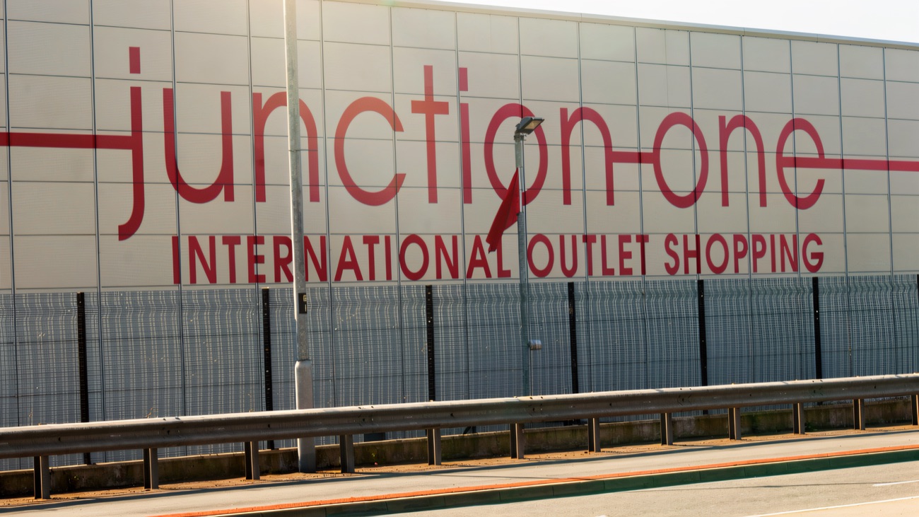 The original 'junction one international outlet shopping' sign on the motorway frontage at Antrim